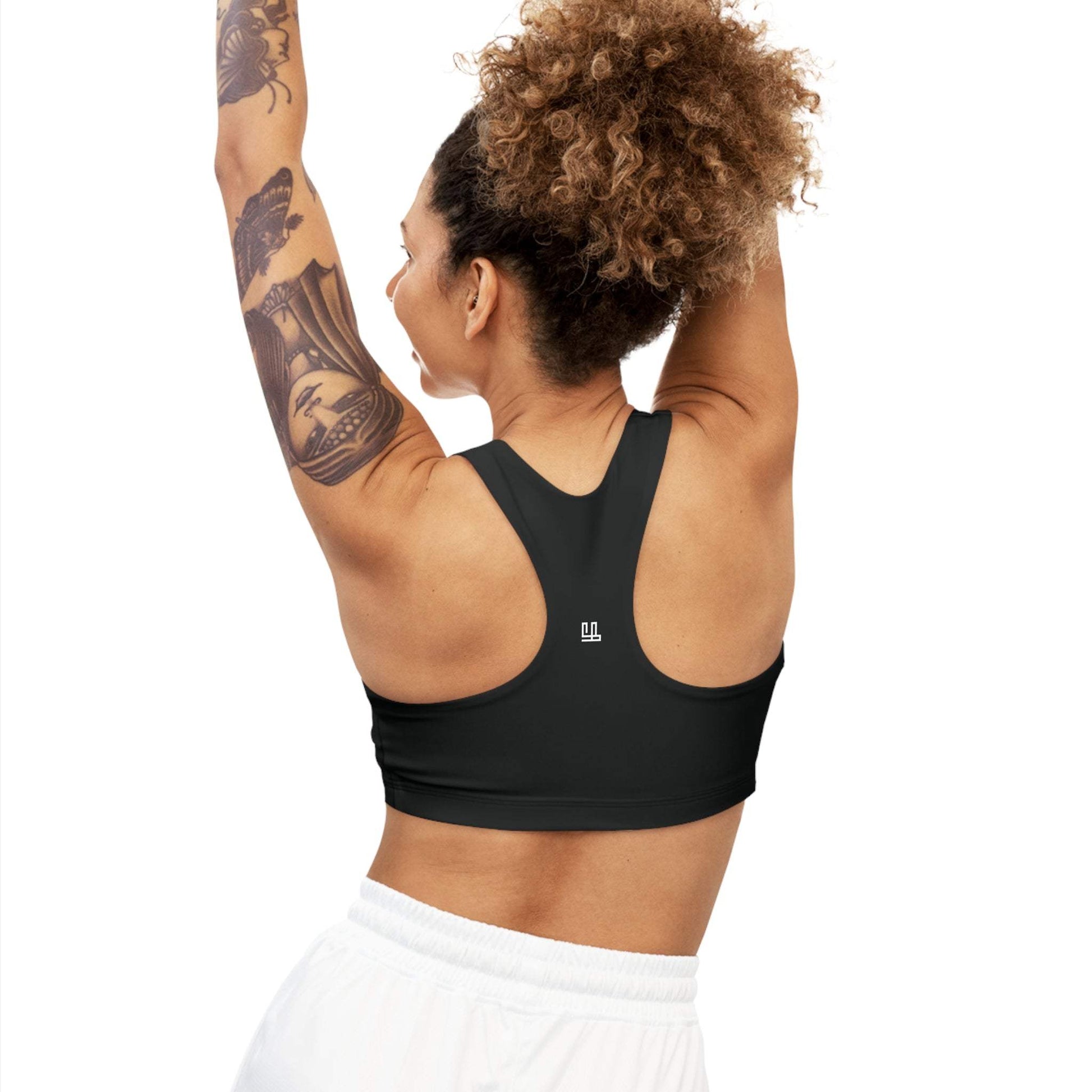 Woman wearing a black Seamless Sports Bra Fearlessli, showcasing back design and comfort fit.