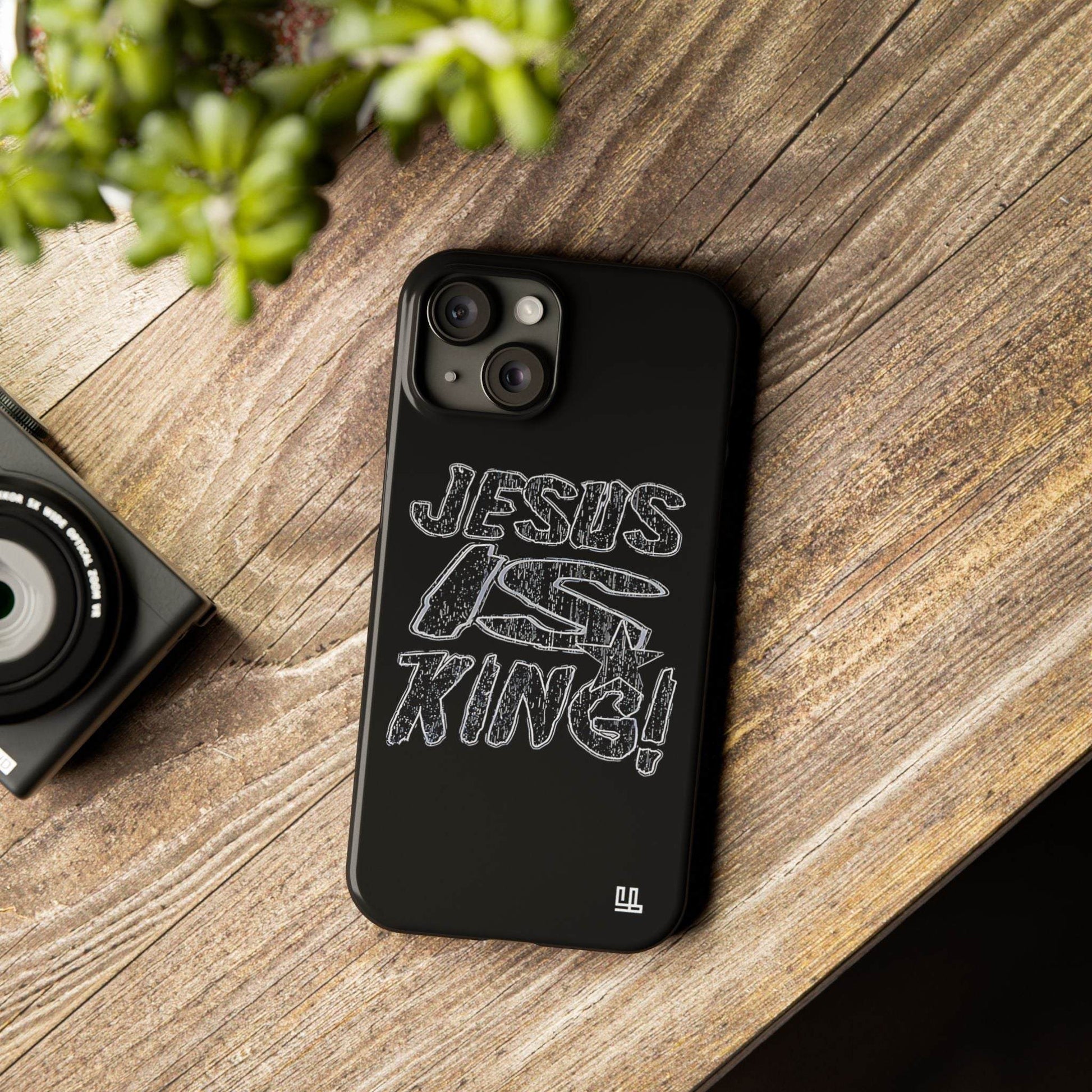 FearlessLi Slim Phone Case on table with "Jesus is King" design.
