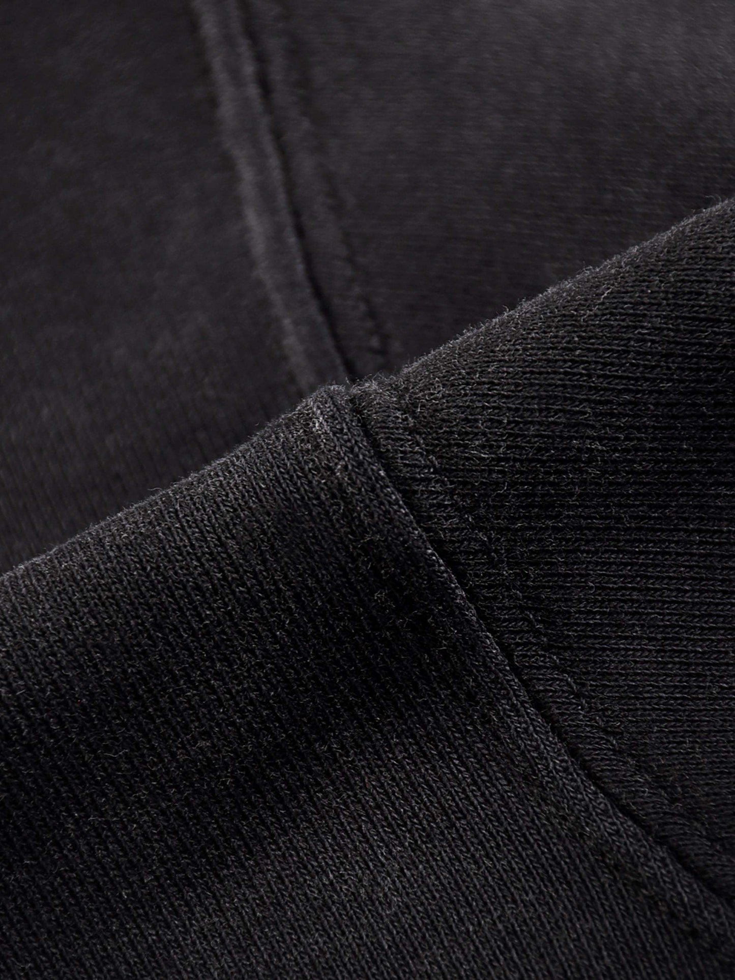 Black fabric detail of Fearless Apparel Li Jesus Is King unisex hoodie, highlighting high-quality material.