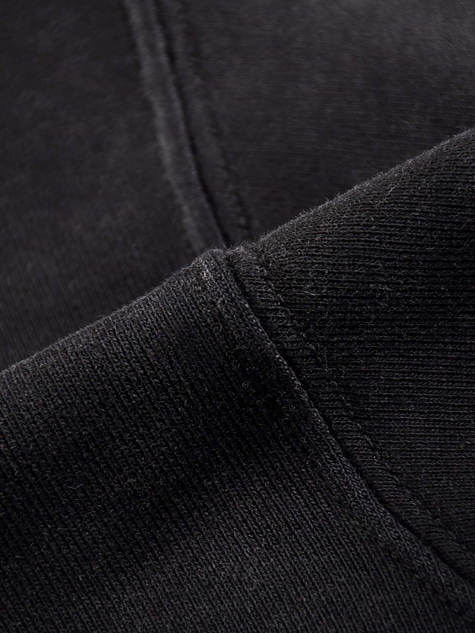 Black fabric detail of Fearless Apparel Li Jesus Is King unisex hoodie, highlighting high-quality material.