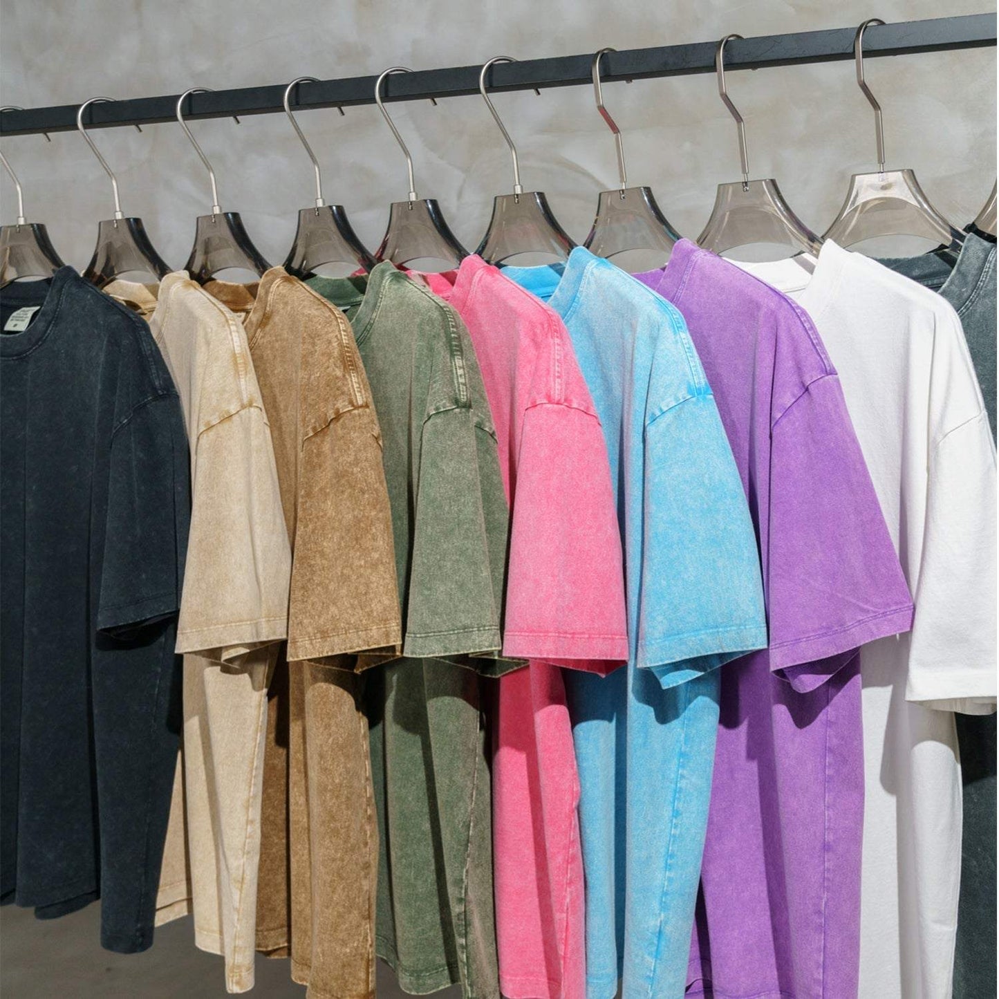 FearLess Motor City T-Shirt with acid washed finish in various colors hanging on a rack.