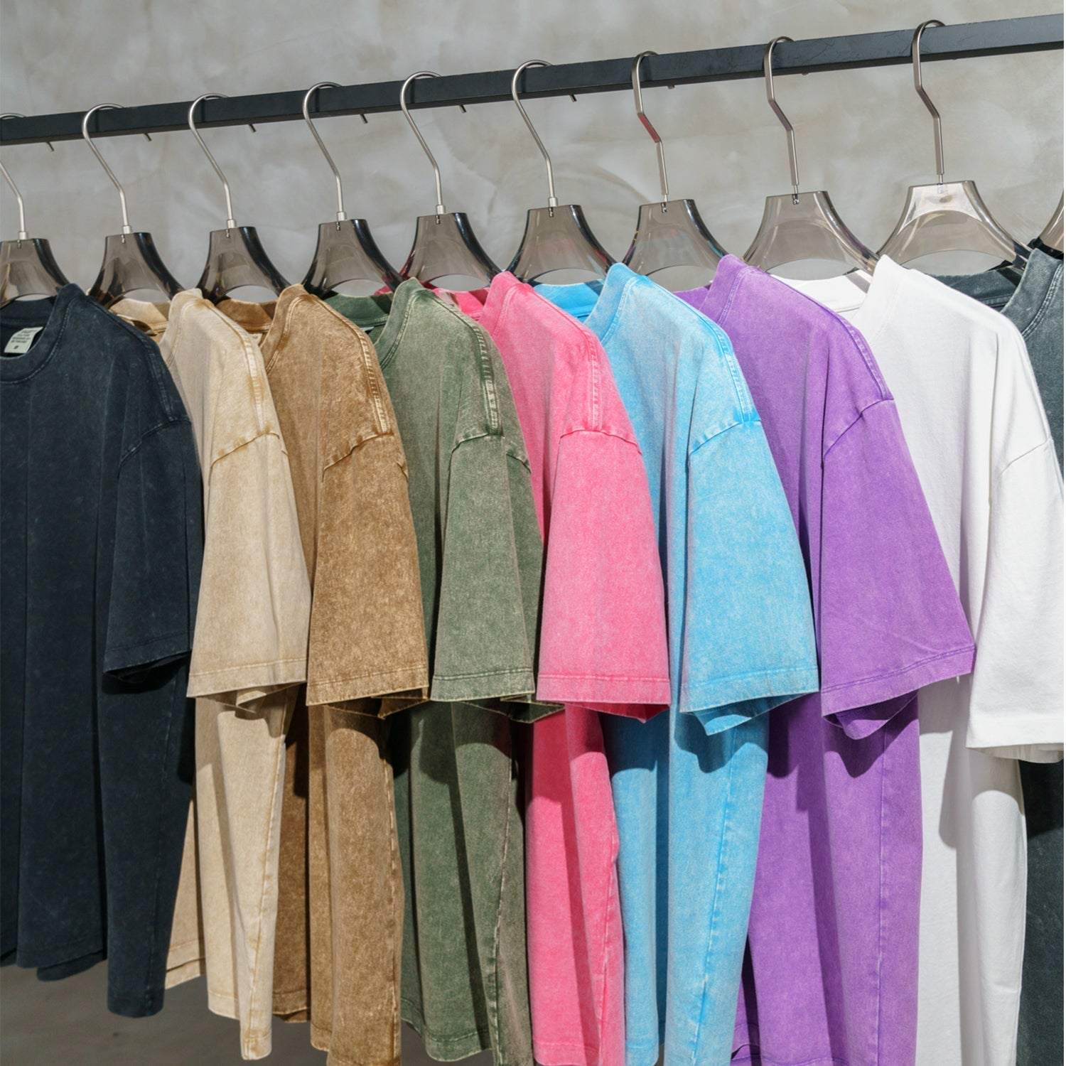 FearLess Motor City T-Shirt with acid washed finish in various colors hanging on a rack.
