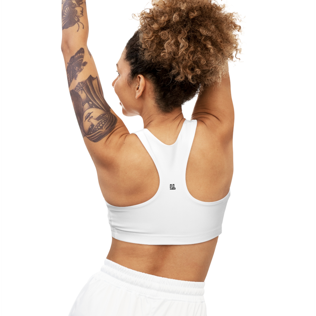 Seamless Sports Bra Fearlessli in white, showing back view with racerback design, worn by a woman with raised arms.