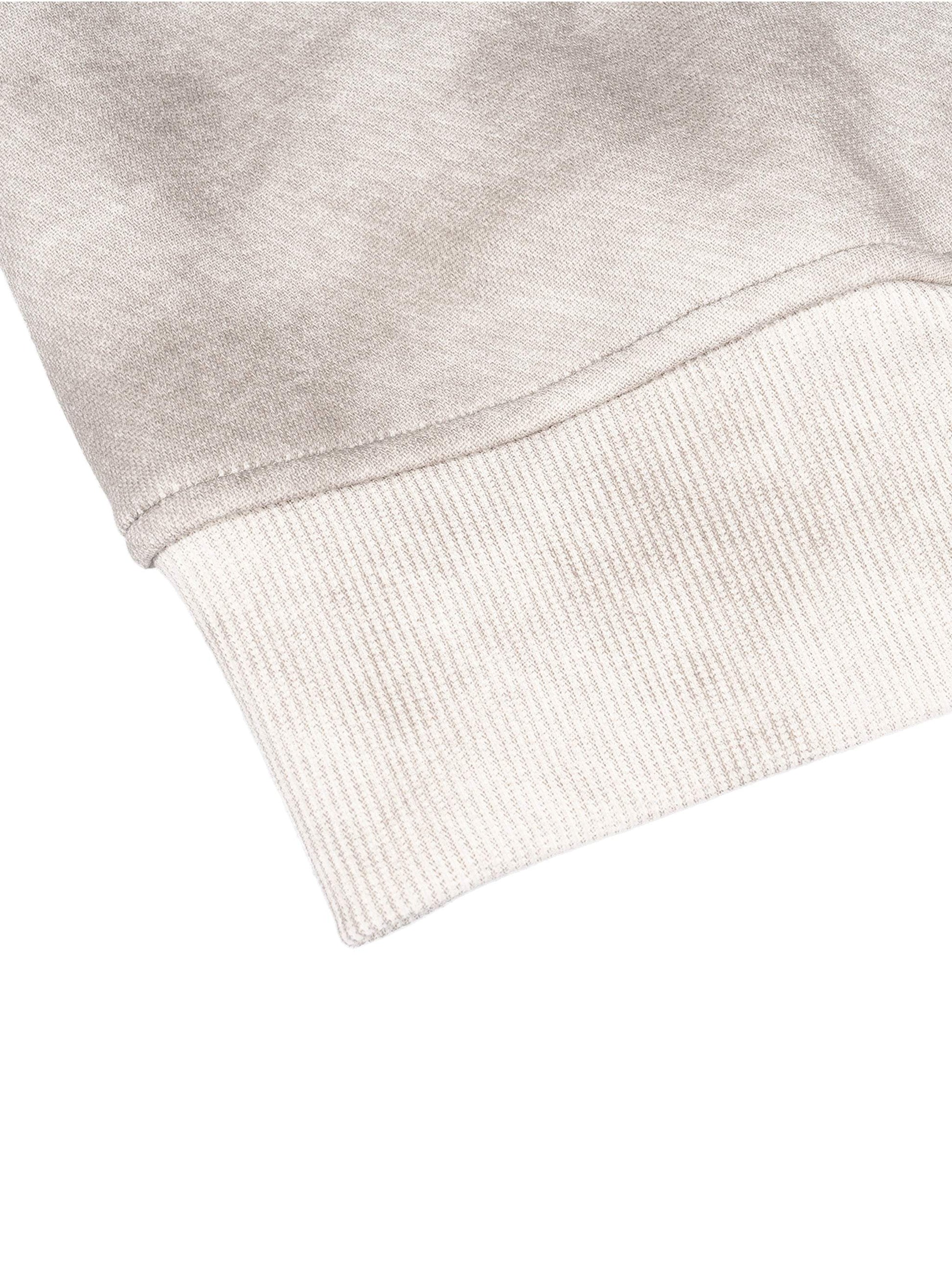 Close-up of a grey dirty washed boxy zip-up fleece hoodie sleeve cuff showing texture and fabric detail.