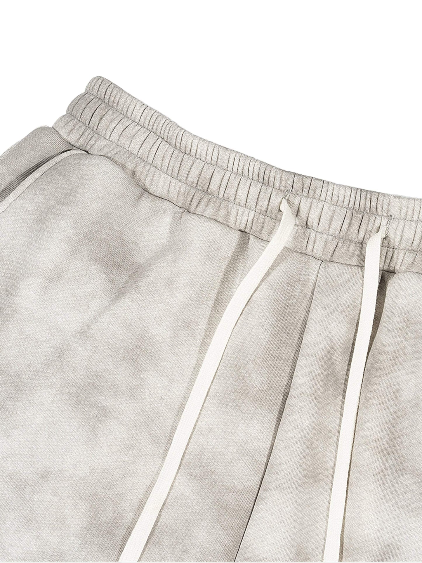 Dirty washed fleece sweatpants in grey with drawstring, displaying relaxed fit and versatile style.