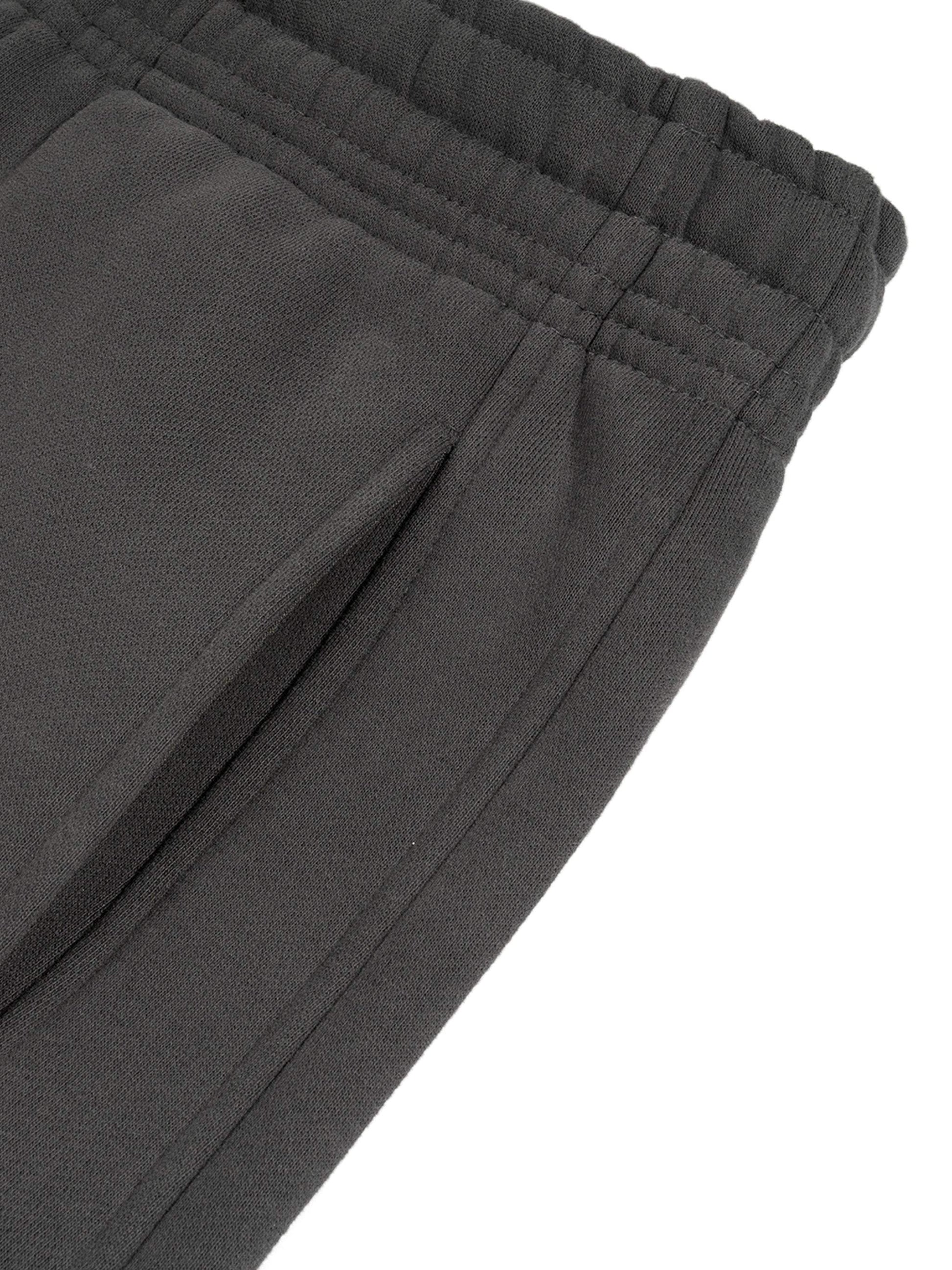 Sunfade Curved Blade Sweatpants in black, close-up of fabric and waist detail.