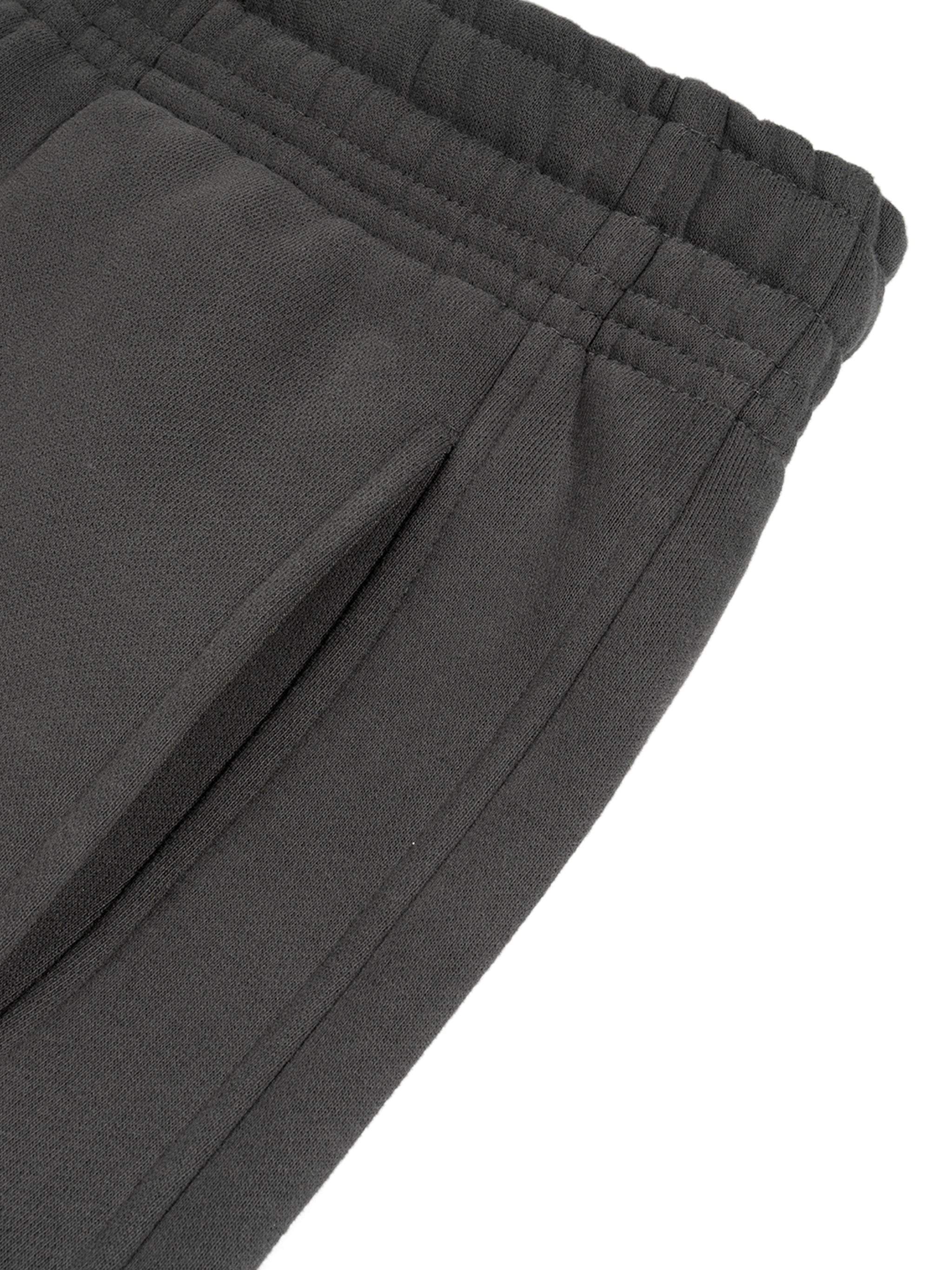 Sunfade Curved Blade Sweatpants in black, close-up of fabric and waist detail.