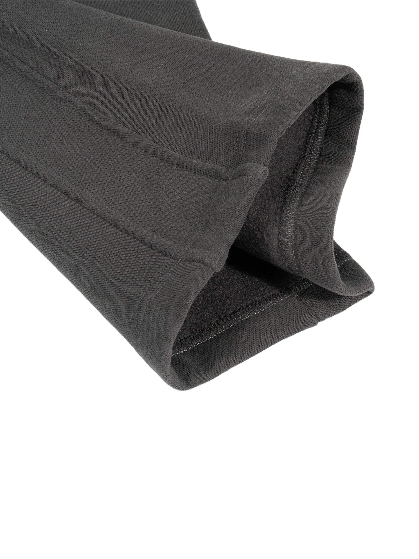 Sunfade Curved Blade Sweatpants in black, close-up of cuff, showing cotton-polyester blend fabric.