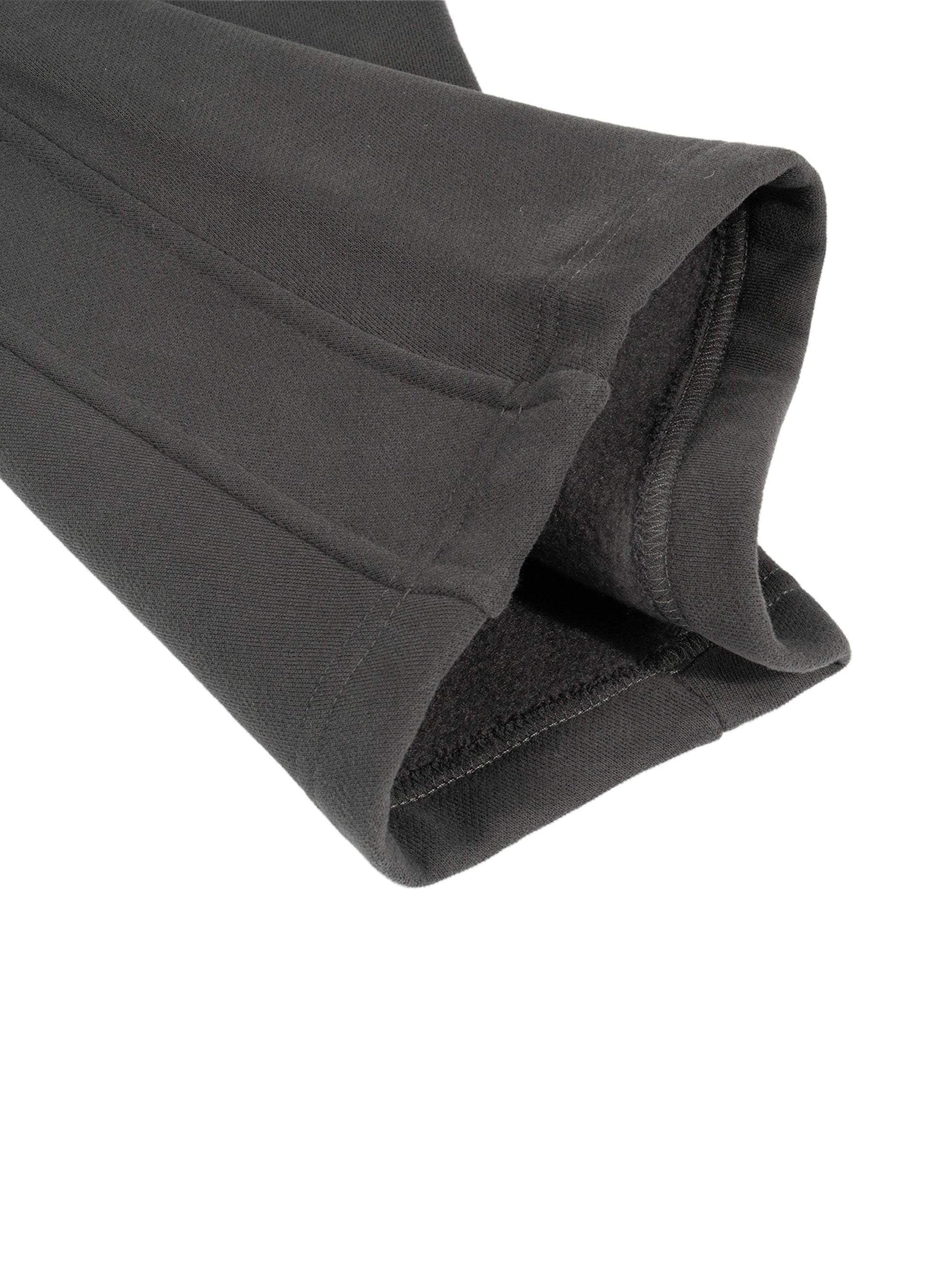 Sunfade Curved Blade Sweatpants in black, close-up of cuff, showing cotton-polyester blend fabric.